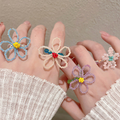 three mixed beaded rings in pink, lavender, green, blue, and white shown worn in a styled second view