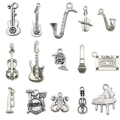 Metallic guitar and musical instrument charms arranged on a light background