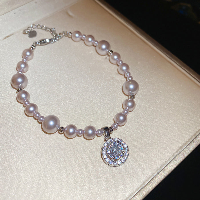 Silver Tone Pink Pearl Like Bracelet With Round Crystal Halo Charm