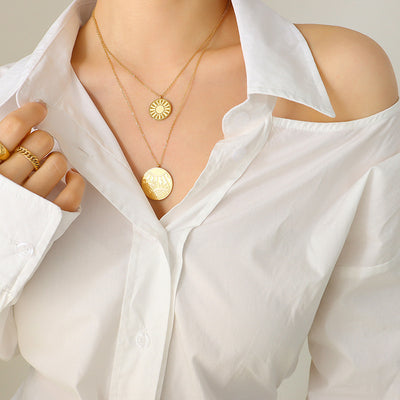 Model in white shirt wearing gold double layer sun disc necklace