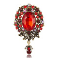 Antique Oval Crystal Dangle Brooch With Faceted Crystals And Polished Metal Details view 1