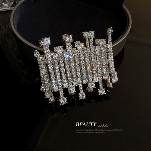 wide silver-tone bracelet made from vertical crystal bars shown worn in a styled second view
