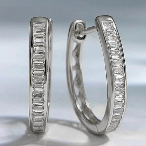 Display view of baguette crystal oval huggie earrings in two colors