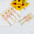 Gold Tone Initial Letter Keychain With Pink Enamel Bow Charm view 1