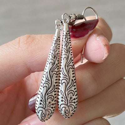 Embossed teardrop dangle earrings in front product view