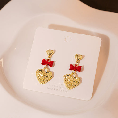 Gold heart stud red bow embossed heart drops on white card dish