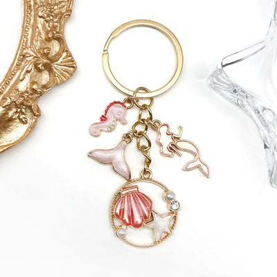 Main display of pink and blue mermaid dolphin seahorse shell keychains