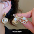 Gold Pearl Drop Earrings in Round and Leaf Frame Designs view 1