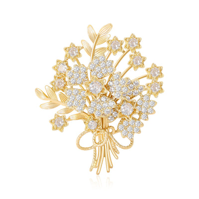 Front view of gold crystal flower bouquet brooch against a white background.
