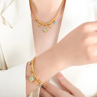 Model wearing matching gold sun turquoise charm necklace and bracelet