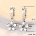 White Flower Charm Huggie Hoop Earrings in Silver Tone view 4