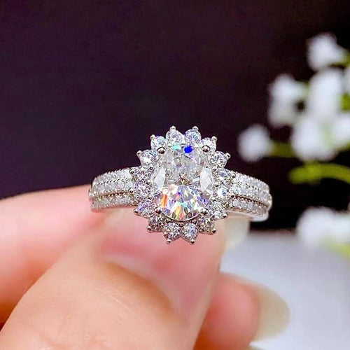 Front view showing a flower-like center cluster and double stone-set shoulders