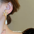 Gold Tone Bow And White Teardrop Pearl Drop Earrings view 3