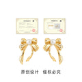 Gold Ribbon Bow Stud Earrings White Pearl Center Pair view 3