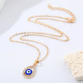 Gold Tone Crystal Teardrop Evil Eye Necklace and Huggie Earrings view 4