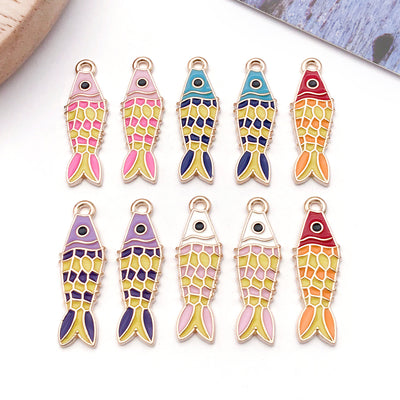 Colorful fish and goldfish charms arranged on a light background