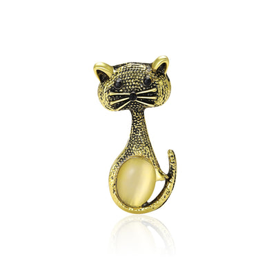 Front product view of the slender antique-gold cat with black features and a rounded golden belly brooch
