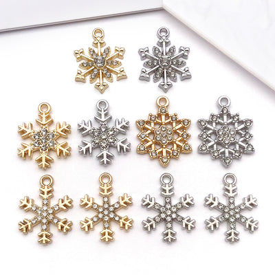 Metallic snowflake charms arranged on a light background