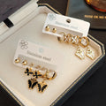 Gold Tone Three Pair Butterfly Stud and Dangle Hoop Earring Set view 1