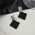 Silver Rippled Oval and Black Diamond Dangle Earrings view 1