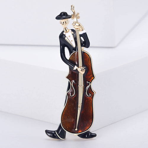 Amber cello player brooch close-up on white