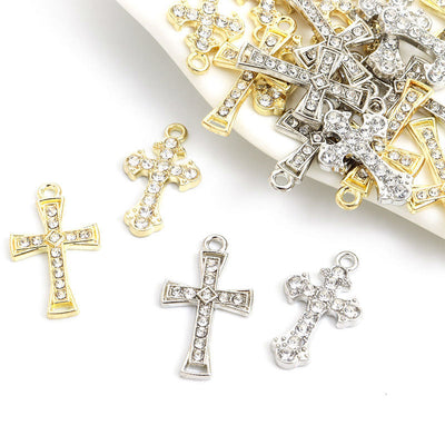 Assorted cross charms arranged on a white surface