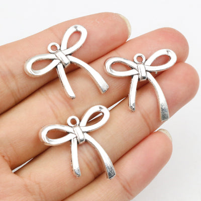 Slim Ribbon Bow Charms arranged in the pictured color and finish options