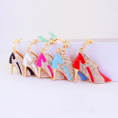Five rhinestone high heel shoe keychains displayed in black, white, hot pink, blue, and red.