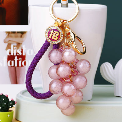 Main image 1 shows a supplied presentation of translucent grape cluster keychains with visible attached key hardware.