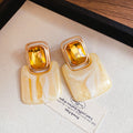 Gold Square Resin Drop Earrings in Amber and Ivory Tones view 6