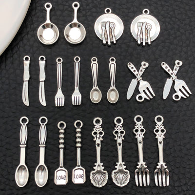 Antique silver assorted shape charms arranged on a light background