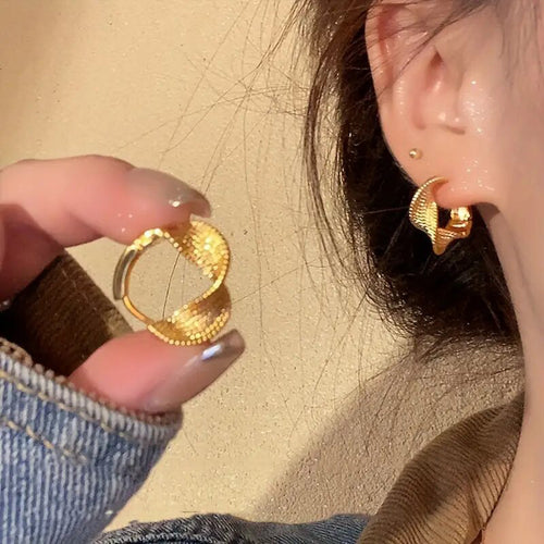 Gold Tone Textured Twist Hoop Earrings Polished Metal Jewelry angled product view