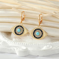 Gold Tone Crystal Turquoise Sun and Evil Eye Huggie Earrings view 3