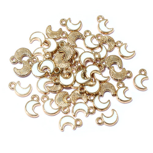 Overview of antique bronze tone crescent moon metal charm pendants arranged on white