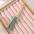 Gold Tone Woven Daisy Bow Tassel Clip Keychains in Four Colors view 3