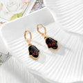 Gold Tone Pressed Flower Hamsa Huggie Earrings in Nine Options view 5