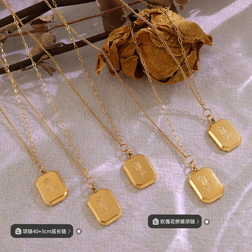 Five gold engraved rose tag pendants laid on fabric with length labels