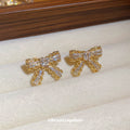 Gold Tone Crystal Bow Dangle Stud Earrings With Polished Metal Details view 4
