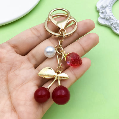 Image 1 showing a person holding a red and white cherry.