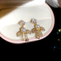 Bow Pearl Drop Stud Earrings In Silver And Gold Tones view 7