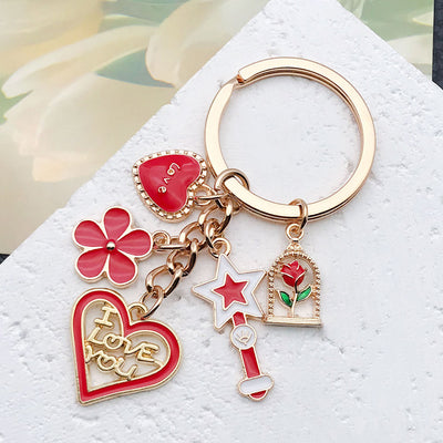 Overview showing the available color and design variations of the red rose heart wand and lipstick metal keychain