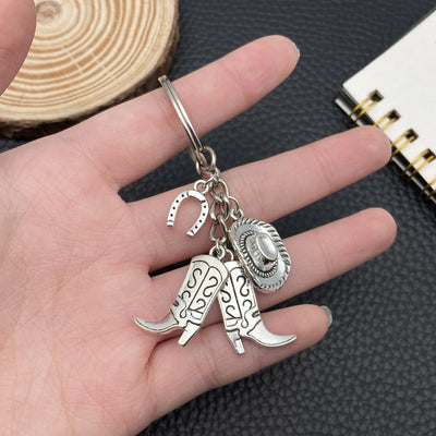 Overview showing the available color and design variations of the antique silver cowboy hat boot and horseshoe keychain