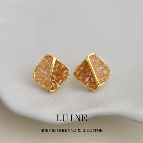 Gold-tone orange-clear crushed-crystal square studs in the first product display.