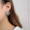 Silver-Tone Open Flower Stud Earrings with Clear Stone Details view 3