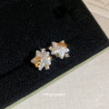 White Flower Star Stud Earrings with Crystal Gold Tone Details view 2