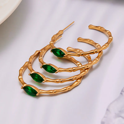 Display view of green glass bamboo texture hoop earrings in main image 1.