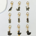 Gold Tone Gothic Skeleton Cat, Duck and Alien Heart-Clasp Charms view 1