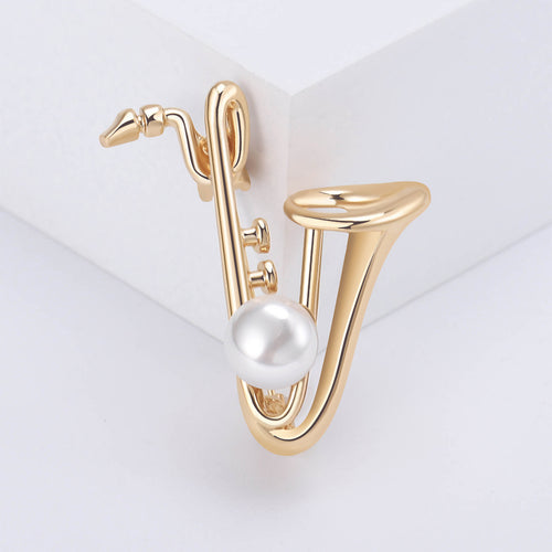 Angled close-up showing crystals on the pearl saxophone brooch
