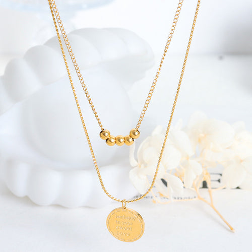 Gold dual chain necklace with five beads and round engraved pendant display