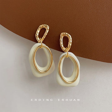 Gold Tone Textured Top And Cream White Open Sculpted Drop Earrings